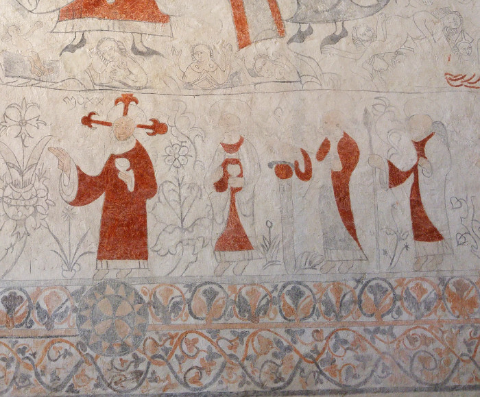Lau kyrka detalj av medeltida kyrkomålning människor växter och dekorativ kant
